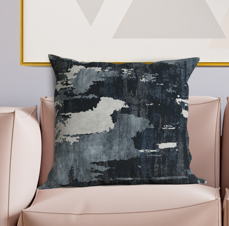 Square decorative pillow with abstract distressed design in dark gray and light gray