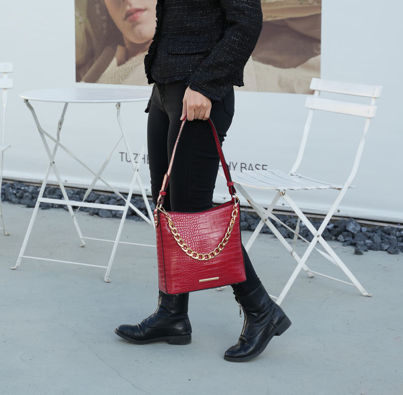Red textured shoulder bag with gold chain strap and leather crossbody strap
