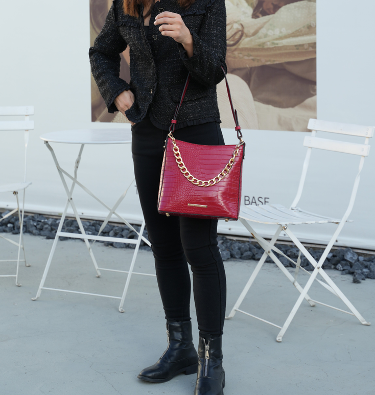 Red textured hobo bag with gold chain shoulder strap and leather crossbody strap