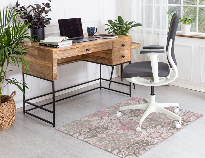 Low-pile multi floral carpet rug shown on light wood floor in front of desk