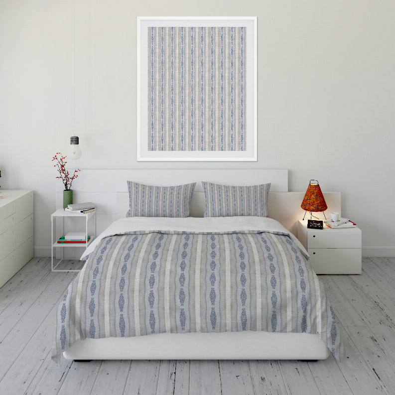 Blue and white vertical stripe comforter set with two pillow shams, neatly draped