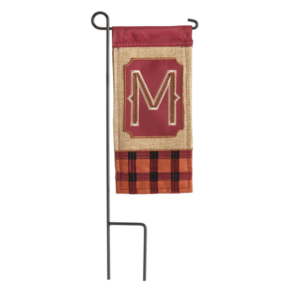 Mini monogram flag: applique M on beige with plaid trim, hung on black pole