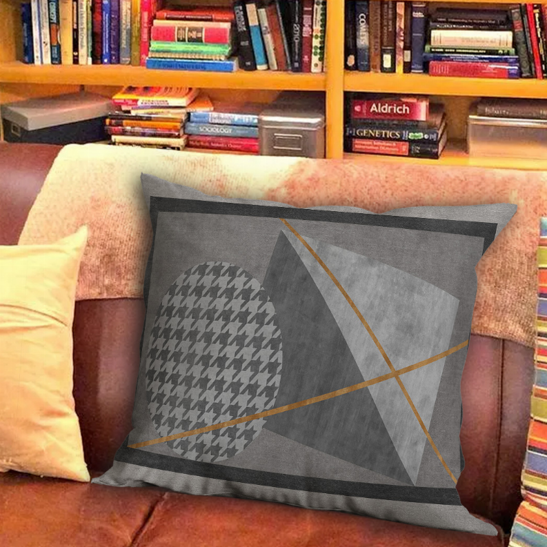 Gray geometric decorative pillow with houndstooth oval and tan intersecting lines