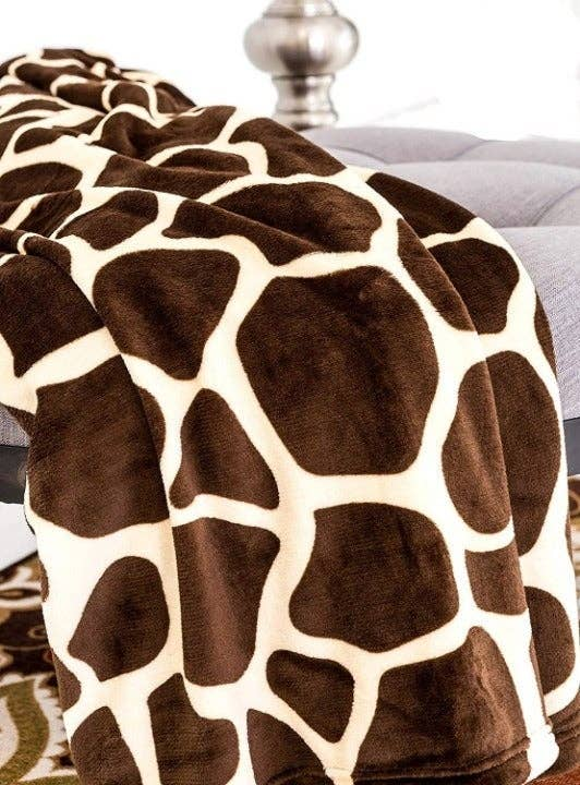 Giraffe plush throw blanket with close-up spotted pattern in brown and cream