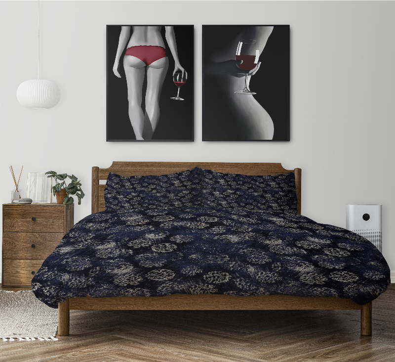 Navy floral-pattern comforter set with two matching shams on bed