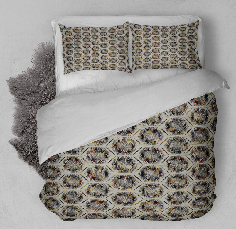Multi-color patterned comforter and two matching pillows on a white bed
