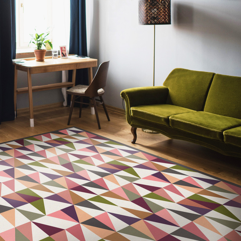 Geometric floor rug with multicolor triangle pattern in pink, olive, cream, and navy