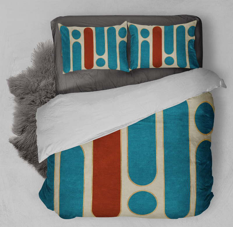 Comforter set with teal geometric print duvet and two matching pillow shams on bed