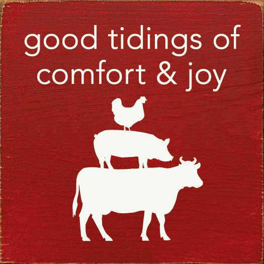 Red holiday sign with white 'good tidings of comfort & joy' and animal silhouettes