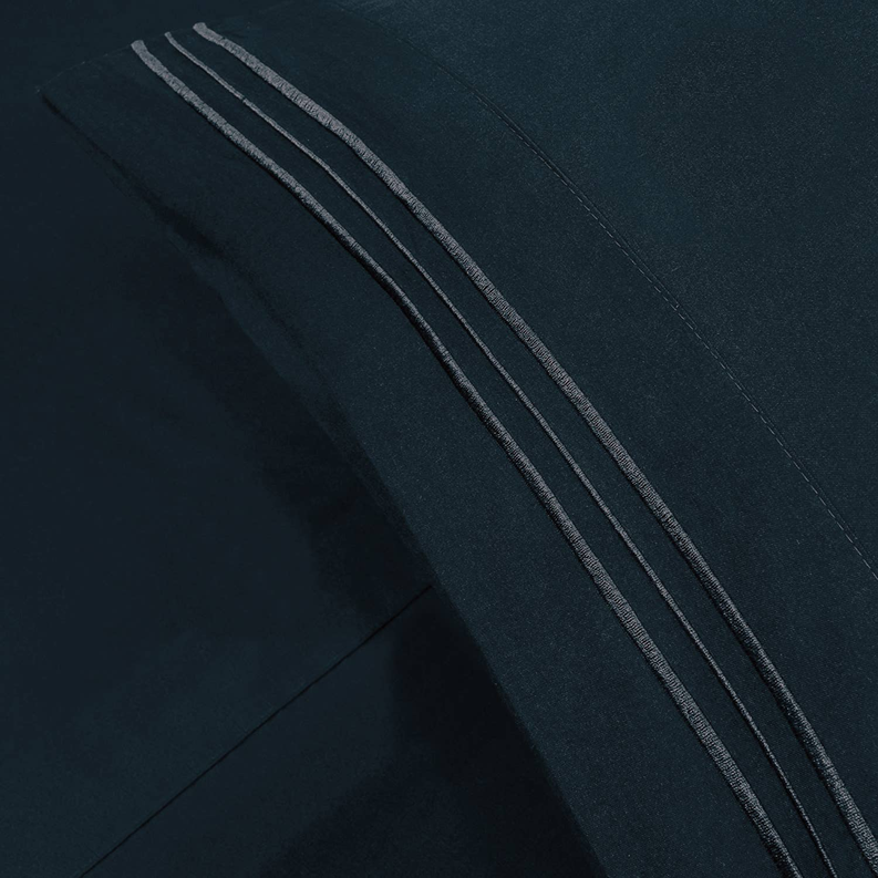 Navy sheet edge detail with three embroidered stripes and fine stitching