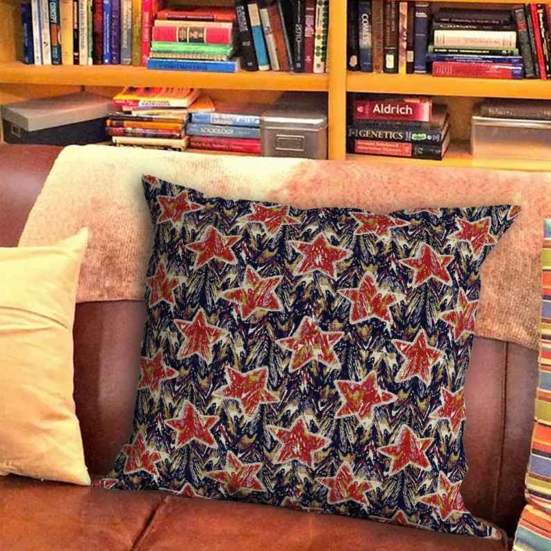 Square throw pillow with red star shapes on dark blue patterned fabric