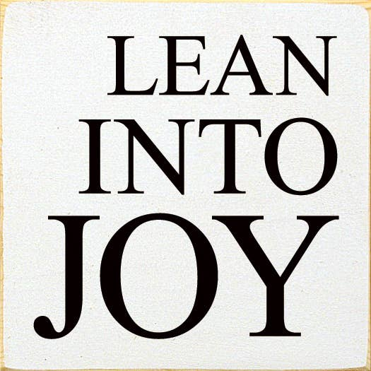 Square wood sign with LEAN INTO JOY in black on cottage white
