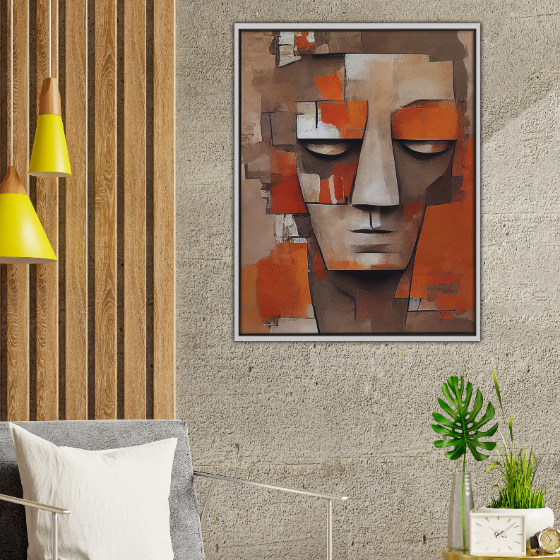 Framed abstract face art print with orange blocks and gray tones on textured wall