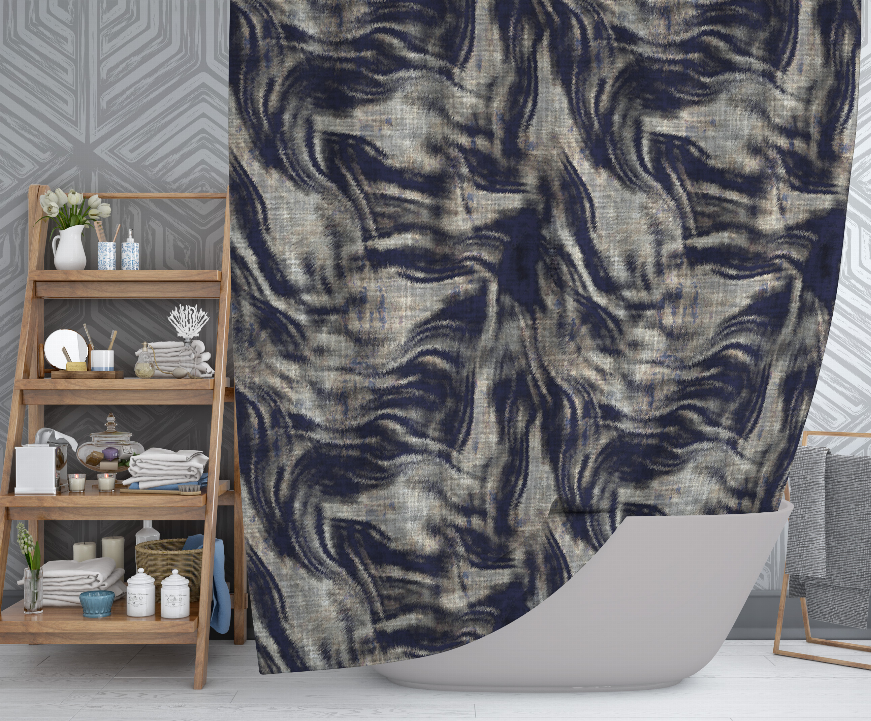 Shower curtain with dark blue-gray swirl pattern hanging over white bathtub