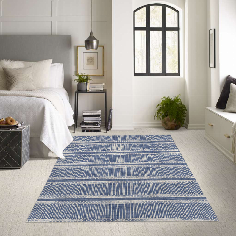 Blue striped low-pile area rug with bordered pattern, multicolor accents