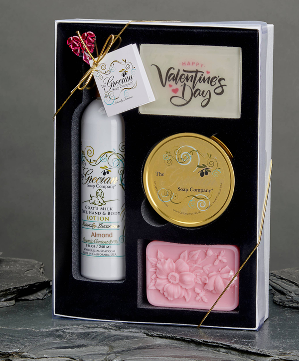 Valentine's Day gift set in a box with lotion bottle, round soap, and pink floral soap bar
