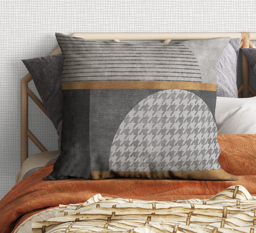 Decorative throw pillow with gray striped band and houndstooth circle on dark gray