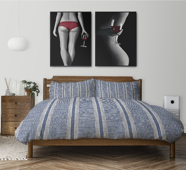 Blue striped comforter set with matching pillows on a bed