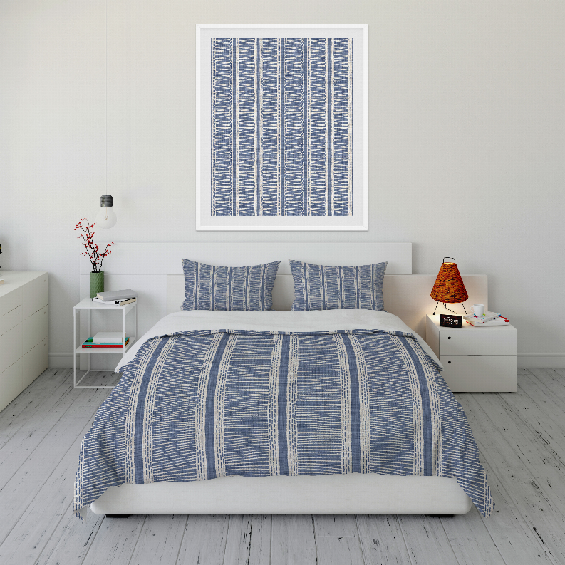 Blue striped comforter set with two pillows on a bed, centered view