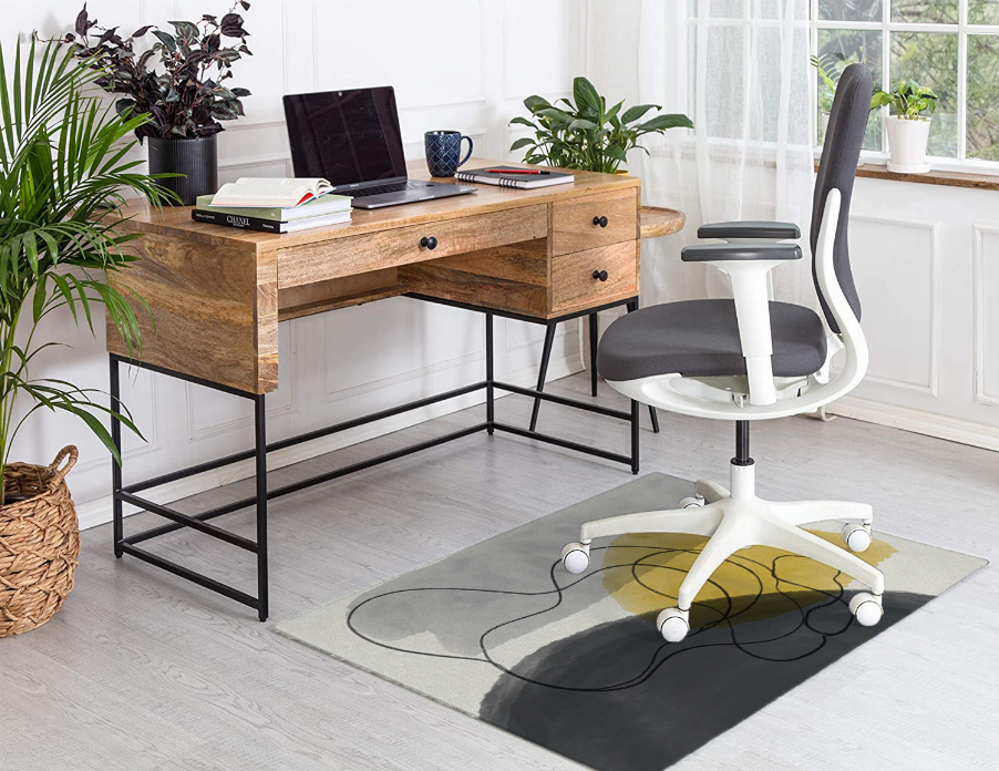Low pile abstract carpet with yellow center and dark gray curved line design.