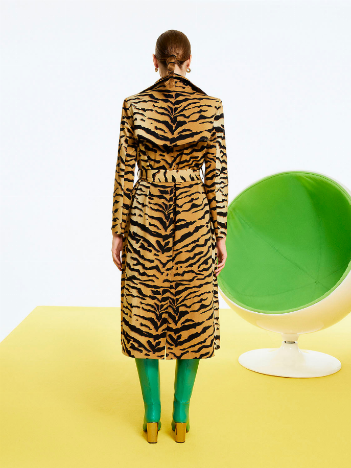Back view of tiger-print trench coat with belted waist and full-length hem