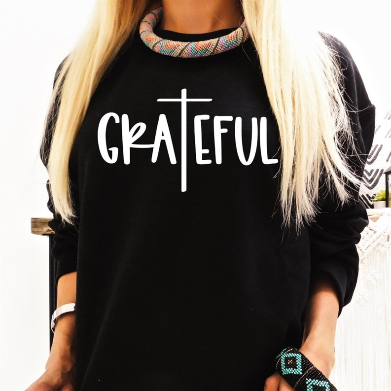 Black crewneck sweatshirt front with white cross and Grateful lettering