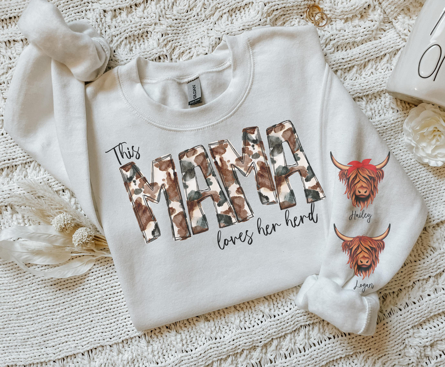 Light cream crewneck sweatshirt with front cow graphic and text 'This mama loves her herd'