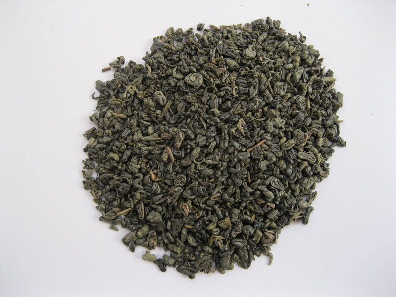 Gunpowder green tea leaves, loose pile of dark green curled leaf buds