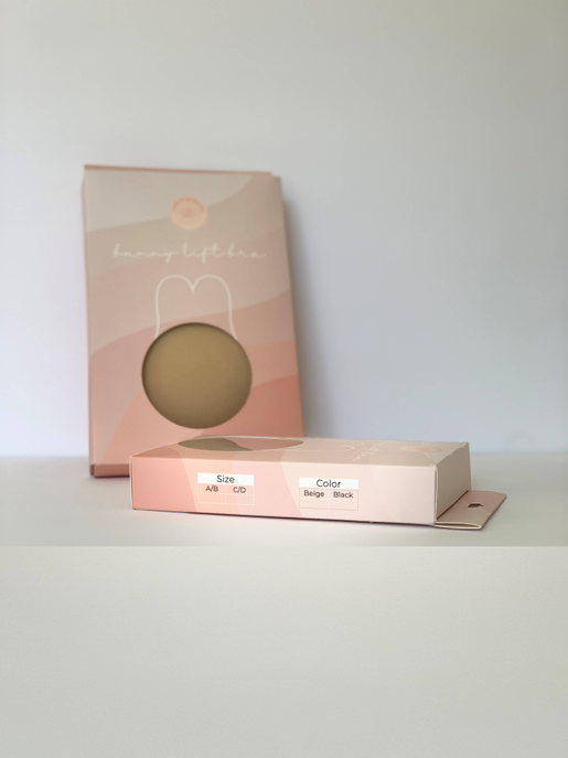 Black bunny lift bra box with size and color labels, plus oval window
