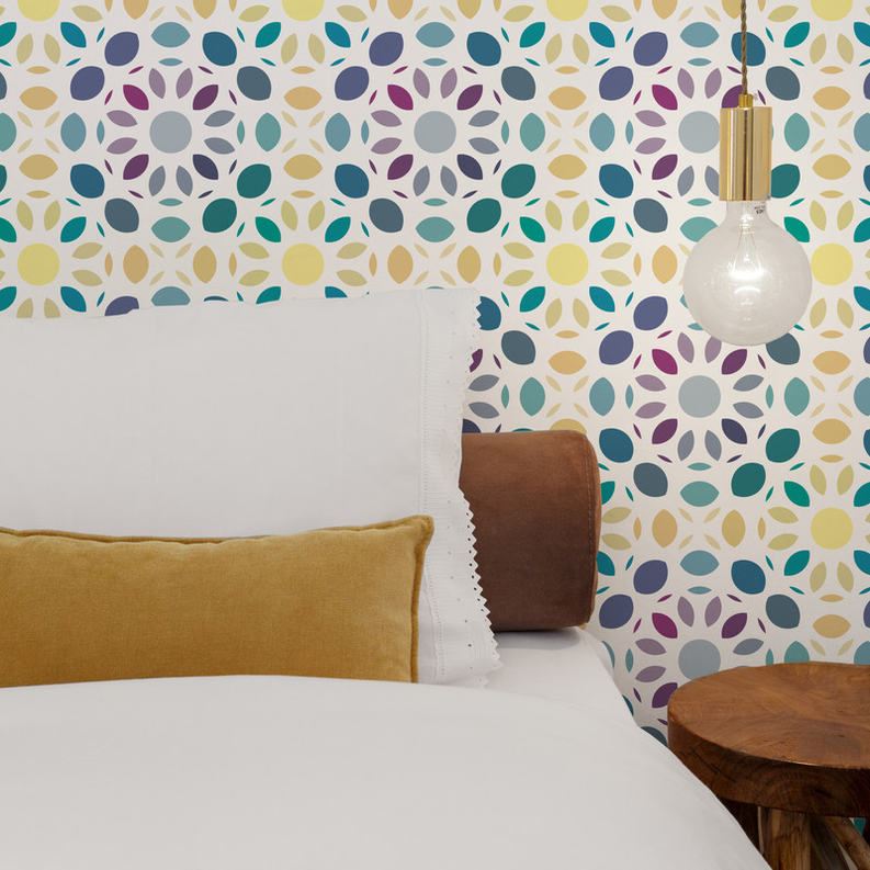 Multi-color mosaic peel-and-stick wallpaper with leaf and dot shapes on wall