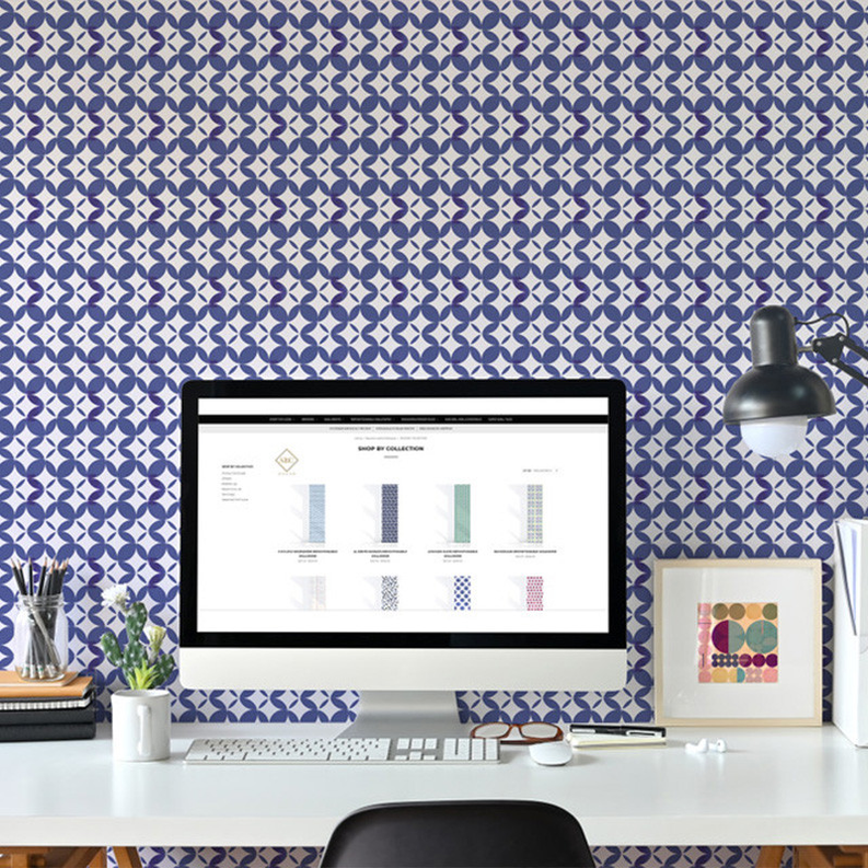 Peel-and-stick wallpaper with navy and light blue interlocking geometric pattern on white