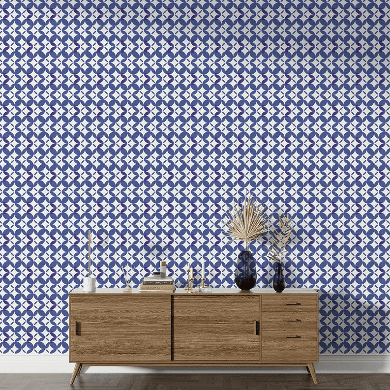 Peel-and-stick wallpaper featuring repeating blue geometric dots and loops on white
