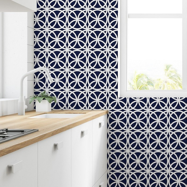 Peel-and-stick wallpaper with navy and white modern medallion lattice pattern on wall