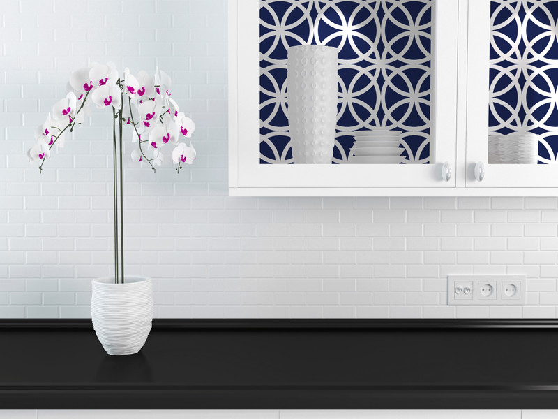 Peel-and-stick wallpaper featuring navy and white interlocking medallion pattern