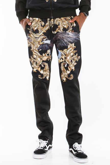 Black printed jogger pants with gold-and-blue baroque graphic, cuffed ankle style