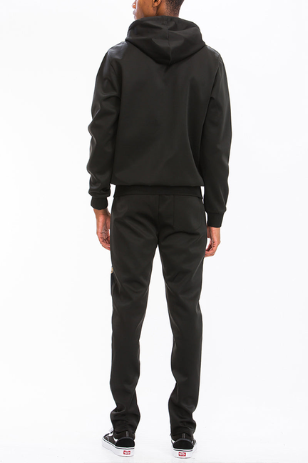 Back view of black zip hoodie and matching black joggers in a track set