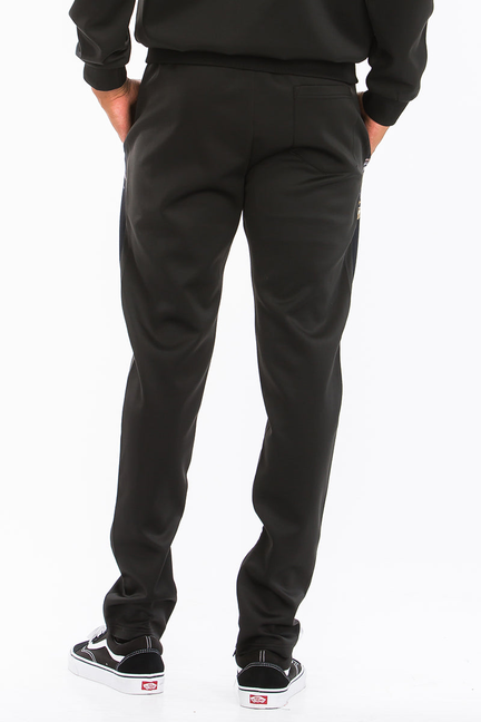 Black solid jogger pants with elastic cuffs and sneakers, no visible print from front