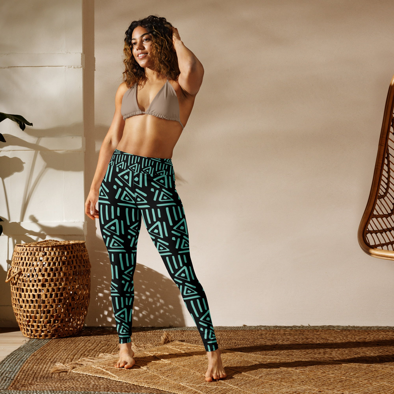 Geometric yoga leggings with teal and green shapes on dark background, ankle length