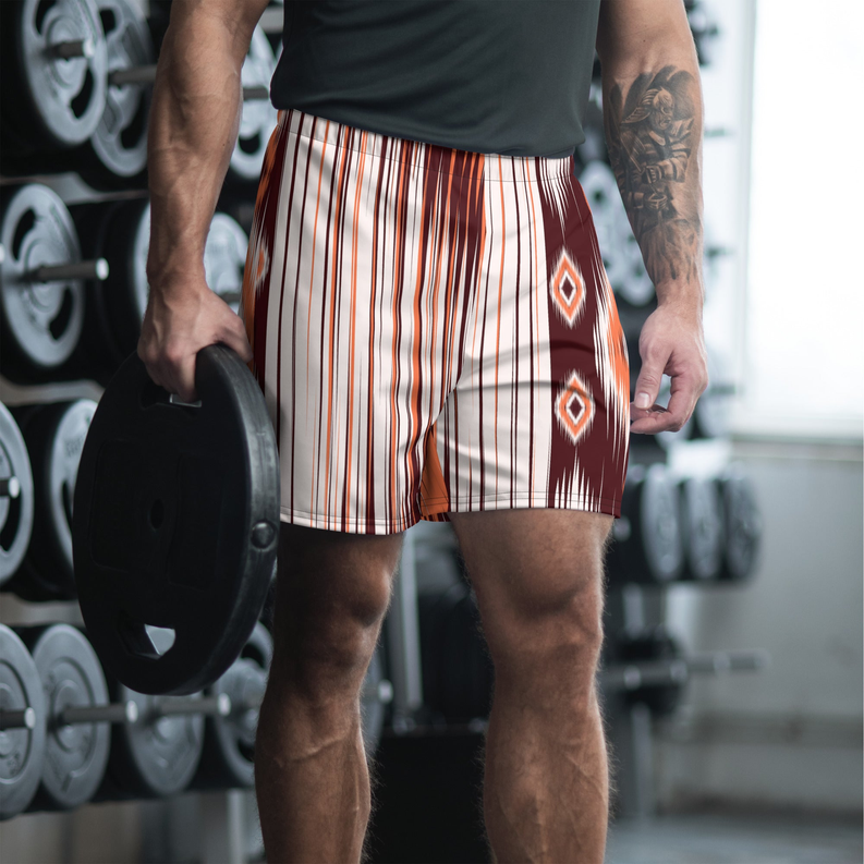 Men's striped swim shorts with dark brown and orange Aztec diamond panels, side view
