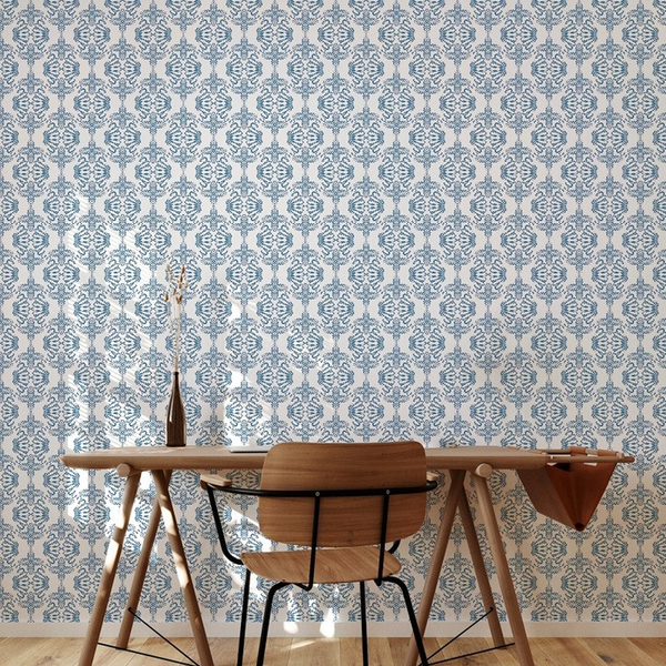 Blue-and-white floral peel-and-stick wallpaper pattern on a wall