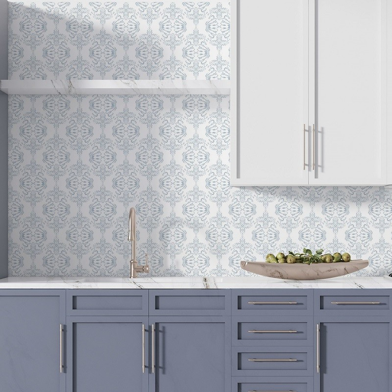 Peel-and-stick wallpaper installed on wall, blue-and-white ornate damask pattern