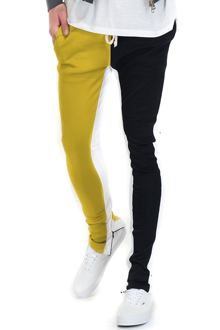 Split-tone track pants with slim legs, yellow left and black right panels