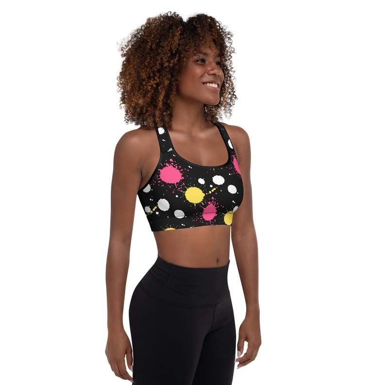 Padded sports bra with black multi-color splash print and racerback straps