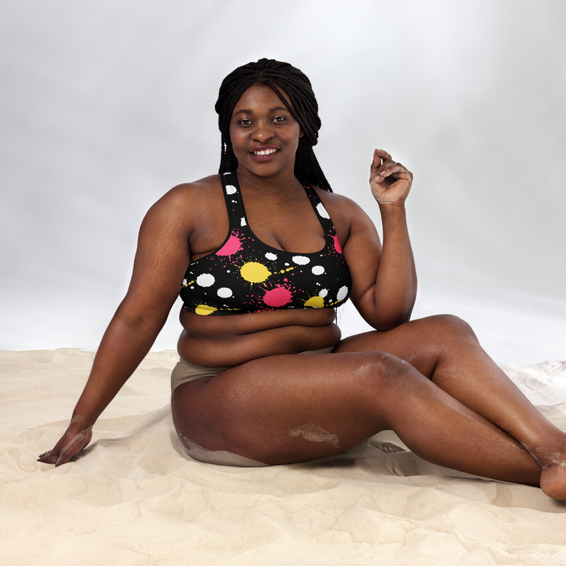 Padded sports bra in black with pink, yellow, and white splatter splash print