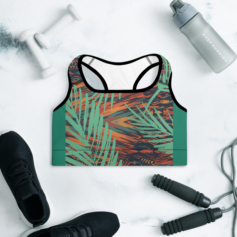 Padded sports bra flat lay, teal green tropical leaf print with contrasting trim
