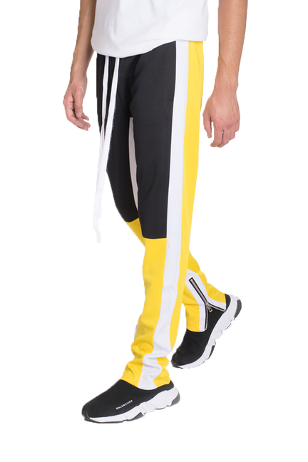 Jordan color block track pants, black with vertical yellow and white stripe, tapered fit