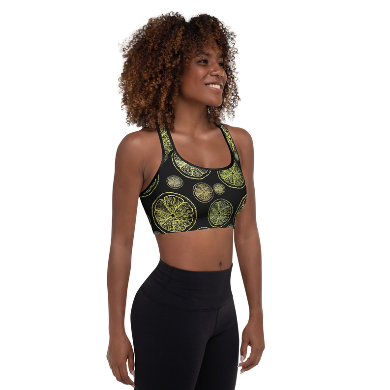 Citrus-print padded sports bra with racerback worn on model, black and lime print