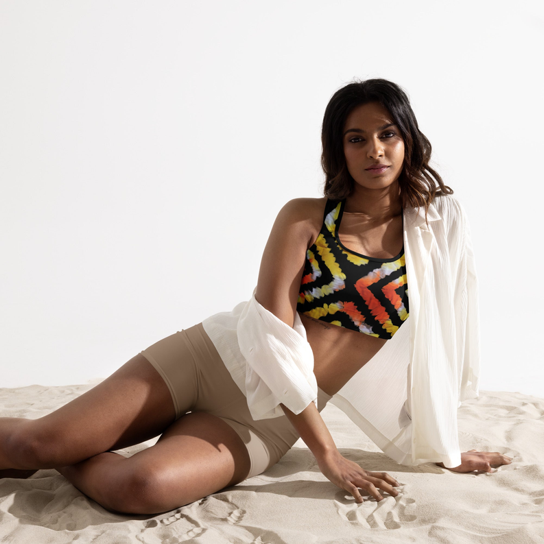Padded sports bra with orange, yellow, and black tie-dye print, racerback