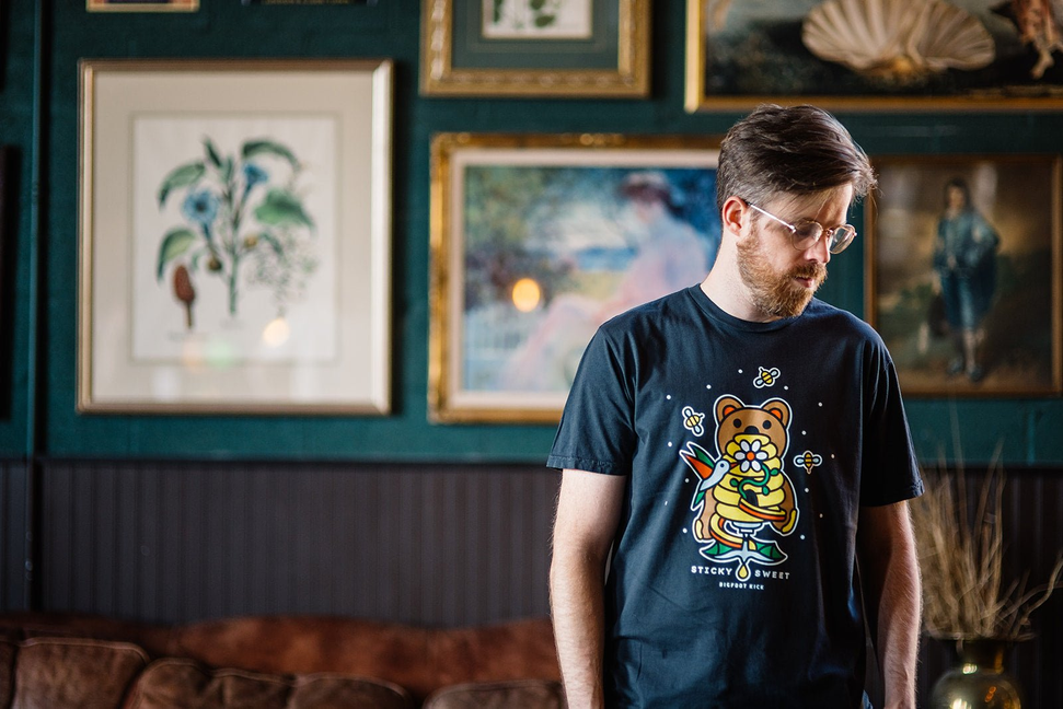 Dark graphic T-shirt with bear mascot illustration on chest