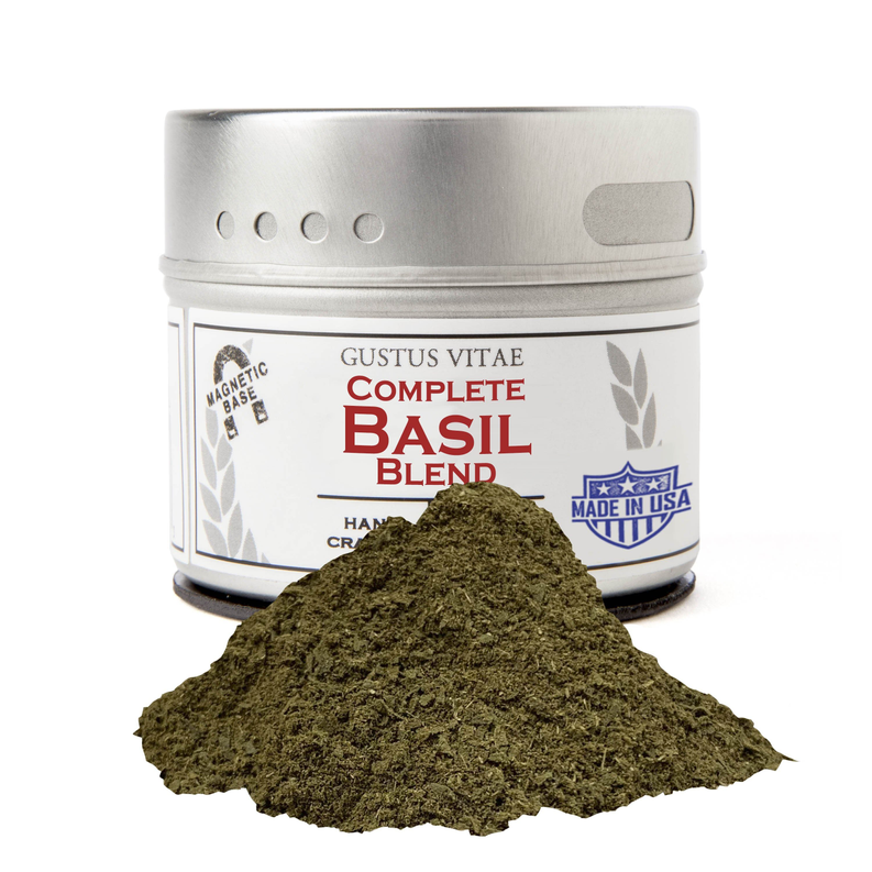 Dried ground basil blend in silver tin with mound of dried leaves